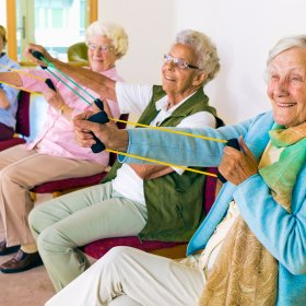 Cheerful senior women exercising their arms.